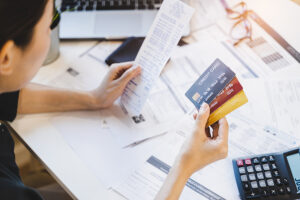 Person reviewing credit card statements and bills during divorce financial planning in Rochester NY